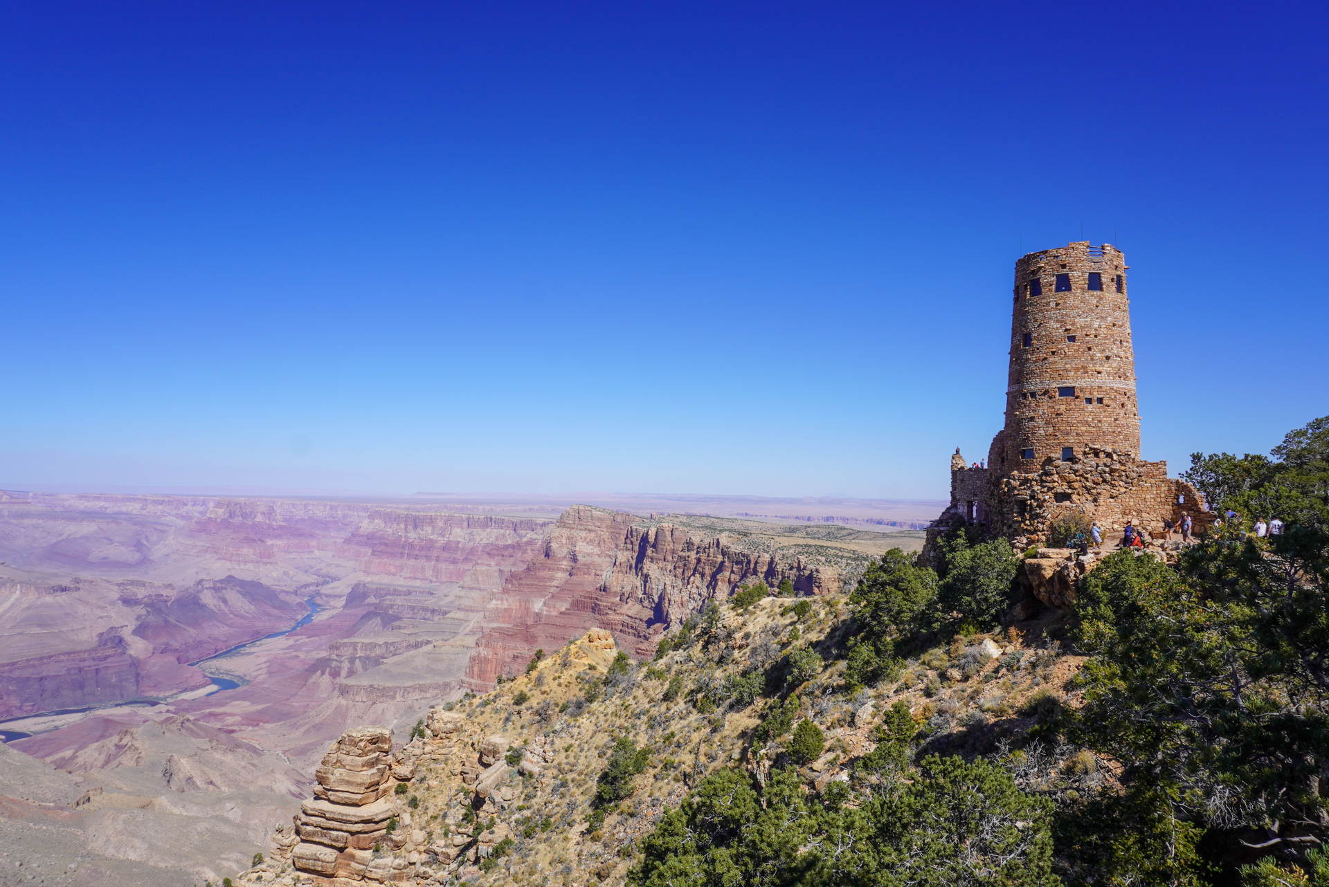 View of a stone tower with an expansive canyon view behind it
