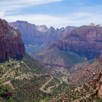 Aerial view of a red rock landscape with a switchback road going through it